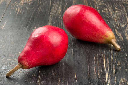 Two ripe red pears on wooden backgroundの写真素材