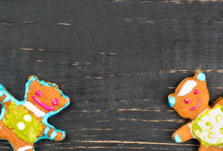 Two home christmas gingerbread bears on a blank wooden background