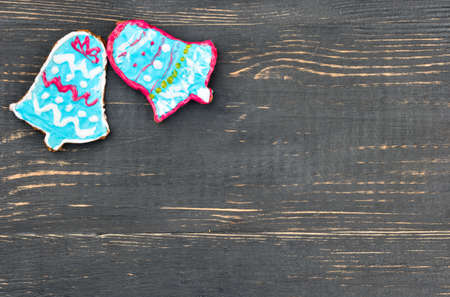 Two christmas gingerbread bells on the empty wooden backgroundの写真素材
