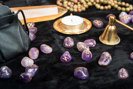 Scattered runes for divination with magical attributes on the table