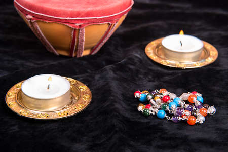 Magical attributes with candles on black background