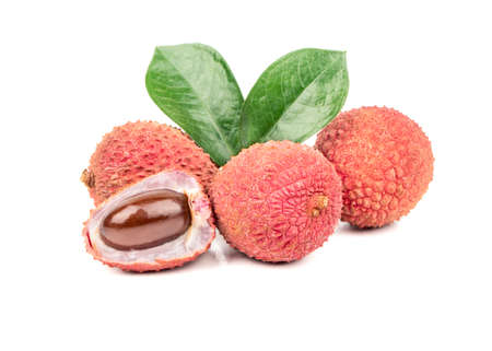 Several Litchi fruits in a shell with half and leaves on a white backgroundの写真素材