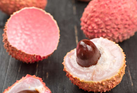Scattered fresh fruit with lychee halves closeup on the tableの写真素材