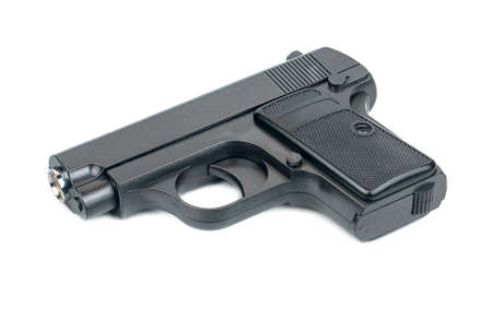 Black metal toy gun isolated on white backgroundの写真素材