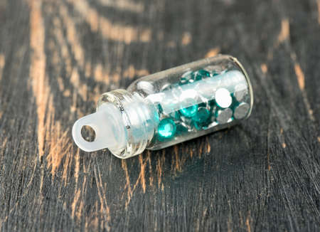 Beautiful sequins in the bottle for the nail design on the tableの写真素材