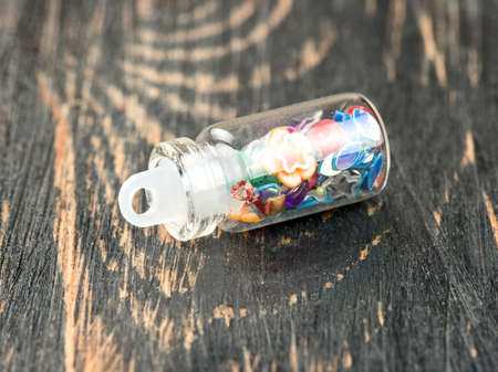 Beautiful sequins in the bottle for the nail design on the tableの写真素材