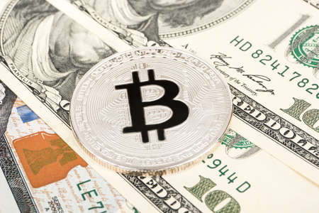 Silver coin bitcoin in dollars close up
