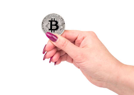 Silver bitcoin coin in female hand on white backgroundの写真素材