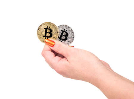 Gold and silver bitcoin coin in female hand on white backgroundの写真素材