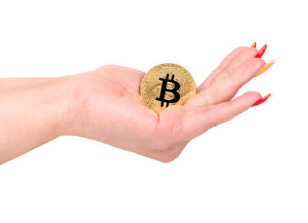 Gold bitcoin coin in female hand on white backgroundの写真素材