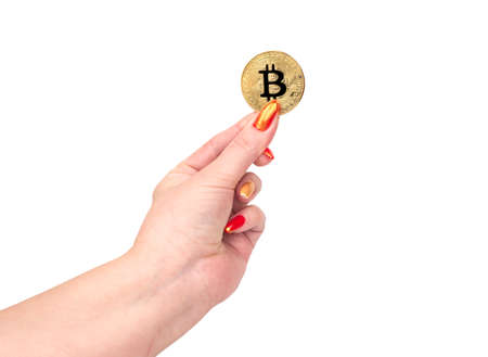 Gold bitcoin coin in female hand on white backgroundの写真素材