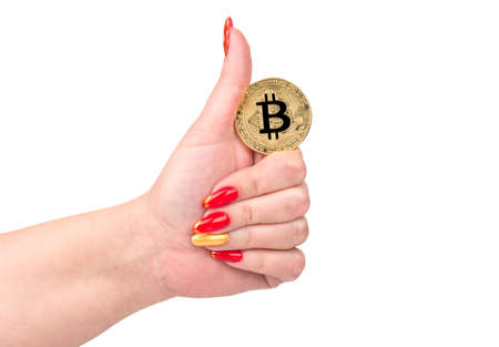 Female hand holding gold bitcoin coin on white backgroundの写真素材