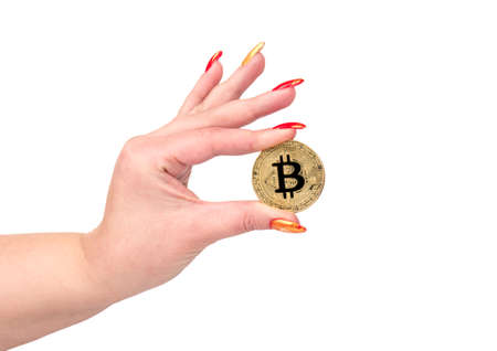 Female hand holding gold bitcoin coin on white backgroundの写真素材