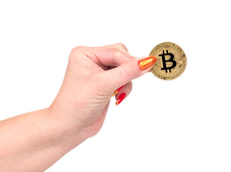 Gold bitcoin coin in female hand on white backgroundの写真素材