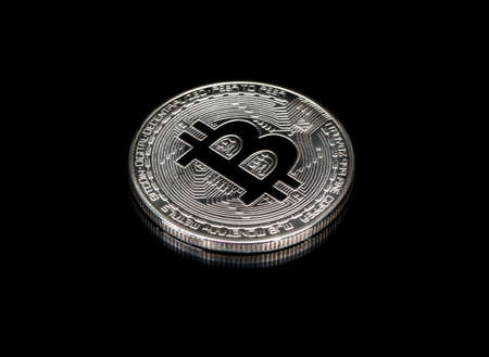 Silver coin bitcoin closeup on black backgroundの写真素材