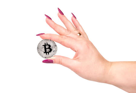 Silver bitcoin coin in female hand on white backgroundの写真素材