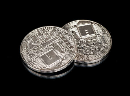 Back side of two silver bitcoin coins on black backgroundの写真素材