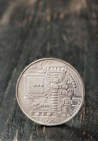 Back side of bitcoin silver coin closeup on tableの写真素材