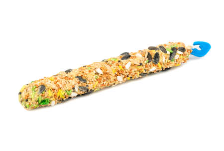 Food for parrots with various cereals on a stick on a white backgroundの写真素材