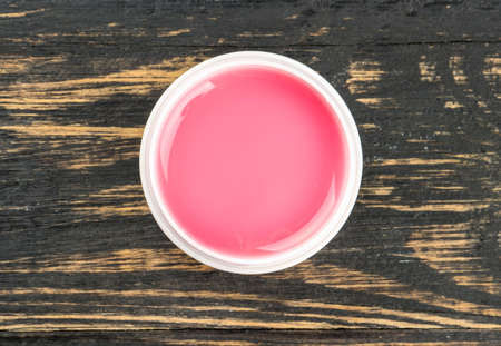 Open gel for nail extensions on a wooden background, top viewの写真素材