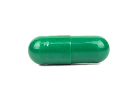Green herbal capsule isolated on white backgroundの写真素材