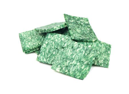 Small slices of cheese with green Basil on white background