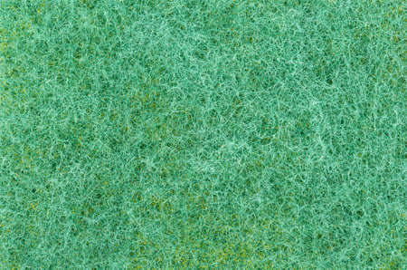 Background of a green sponge for washing dishes, close-upの写真素材