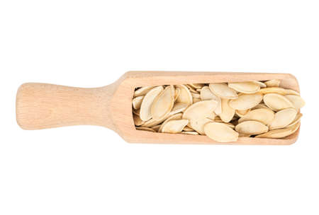 Pumpkin seeds in scoop on isolated background, top viewの写真素材