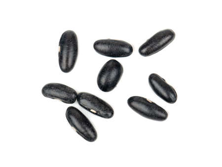 Several scattered black beans isolated on white background, top view