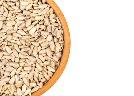 Part of a bowl of sunflower seeds without a shell on a white background, top viewの写真素材