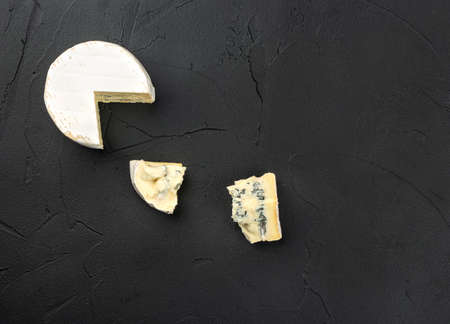 Brie cheese with two slices on concrete background, top viewの写真素材