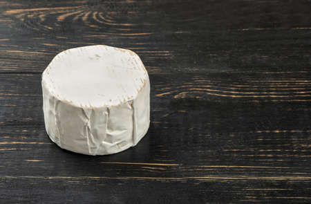 Brie cheese with mold on wooden backgroundの写真素材
