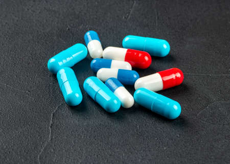 Scattered colorful capsules on a concrete backgroundの写真素材