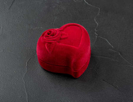 Red box for rings in the shape of a heart on a concrete backgroundの写真素材