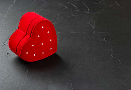 Red box for rings in the shape of a heart on a concrete backgroundの写真素材