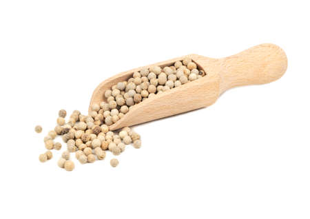 White peppercorns in a wooden scoop on a light backgroundの写真素材