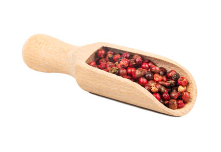 Red pepper in a wooden scoop closeup on white backgroundの写真素材