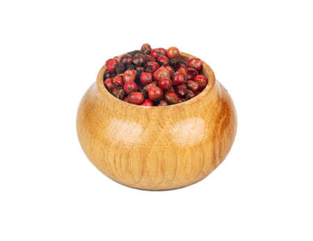 Small wooden bowl with red pepper peas on white backgroundの写真素材