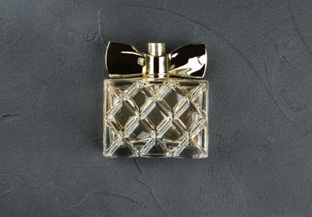 Bottle of womens perfume close-up on a dark background, top viewの写真素材