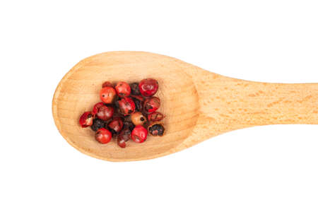 Small spoon with red pepper peas isolated on white background, top viewの写真素材