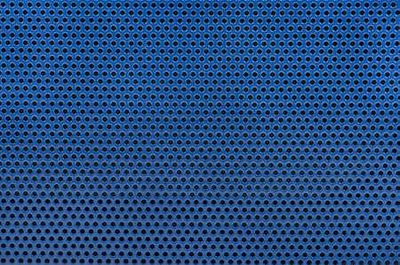 Blue background of metal mesh in the hole close-upの写真素材