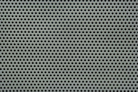 Gray background of metal mesh in the hole close-upの写真素材