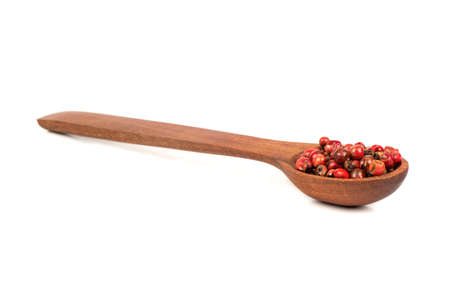 Dry red pepper peas in wooden spoon isolated on white backgroundの写真素材