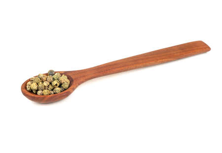 Green pepper peas in wooden spoon on a white backgroundの写真素材