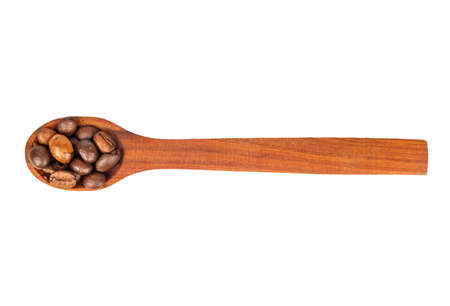 Dry coffee beans in wooden spoon on white background, top viewの写真素材