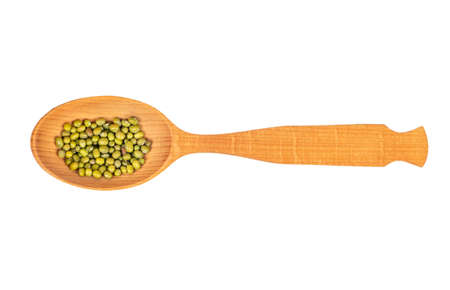Several green mung beans in a large wooden spoon on a white background, top viewの写真素材