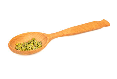 Several green mung beans in a large wooden spoon on a white backgroundの写真素材