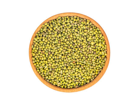 Wooden bowl with green mung grains isolated on white background, top viewの写真素材