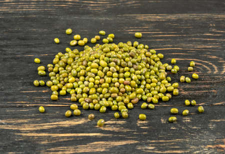 Bunch of green mung beans on a wooden backgroundの写真素材