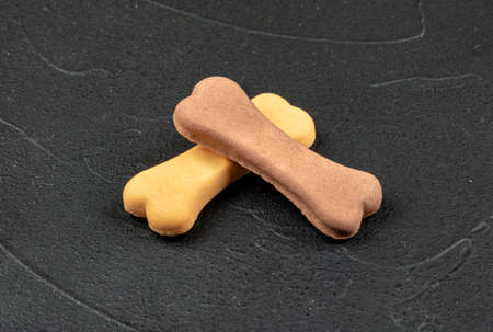 Dog biscuits in the shape of a bone on a concrete backgroundの写真素材